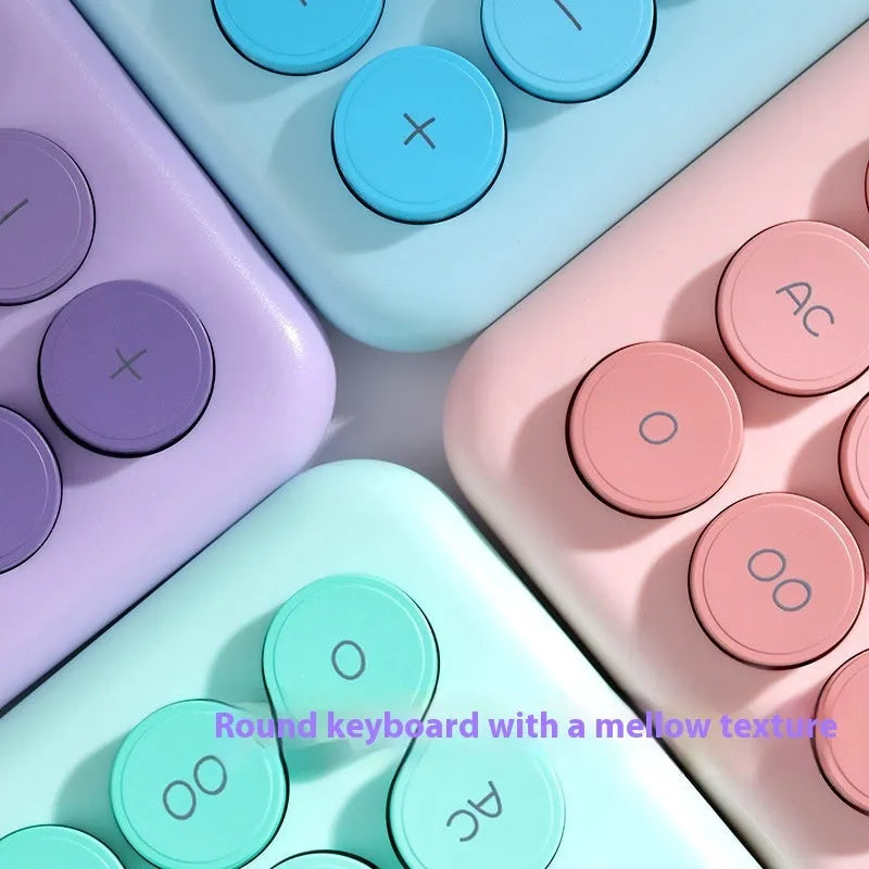 12-digit gradient colour desktop calculator in violet, blue, green, or pink on a desk