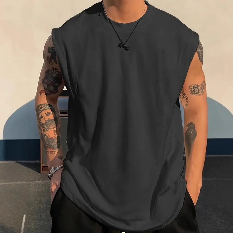 Man wearing a loose-fit solid colour cotton sleeveless tank top for summer.