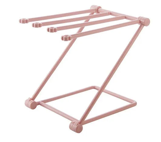 Foldable plastic towel shelf with vertical storage in light pink Nordic kitchen organiser