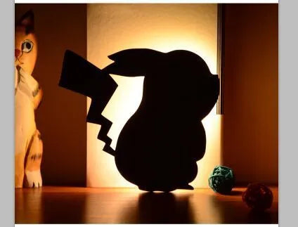 Cat-shaped LED night light with sound sensor on a wall, emitting warm yellow light.