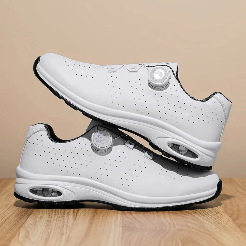 Black and white low top mesh casual shoes with lace-up front and cross shoulder straps on a composite sole.