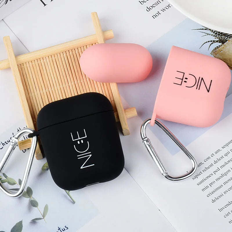 Black and pink polycarbonate AirPods case covers with decorative flower and smiley face back designs.