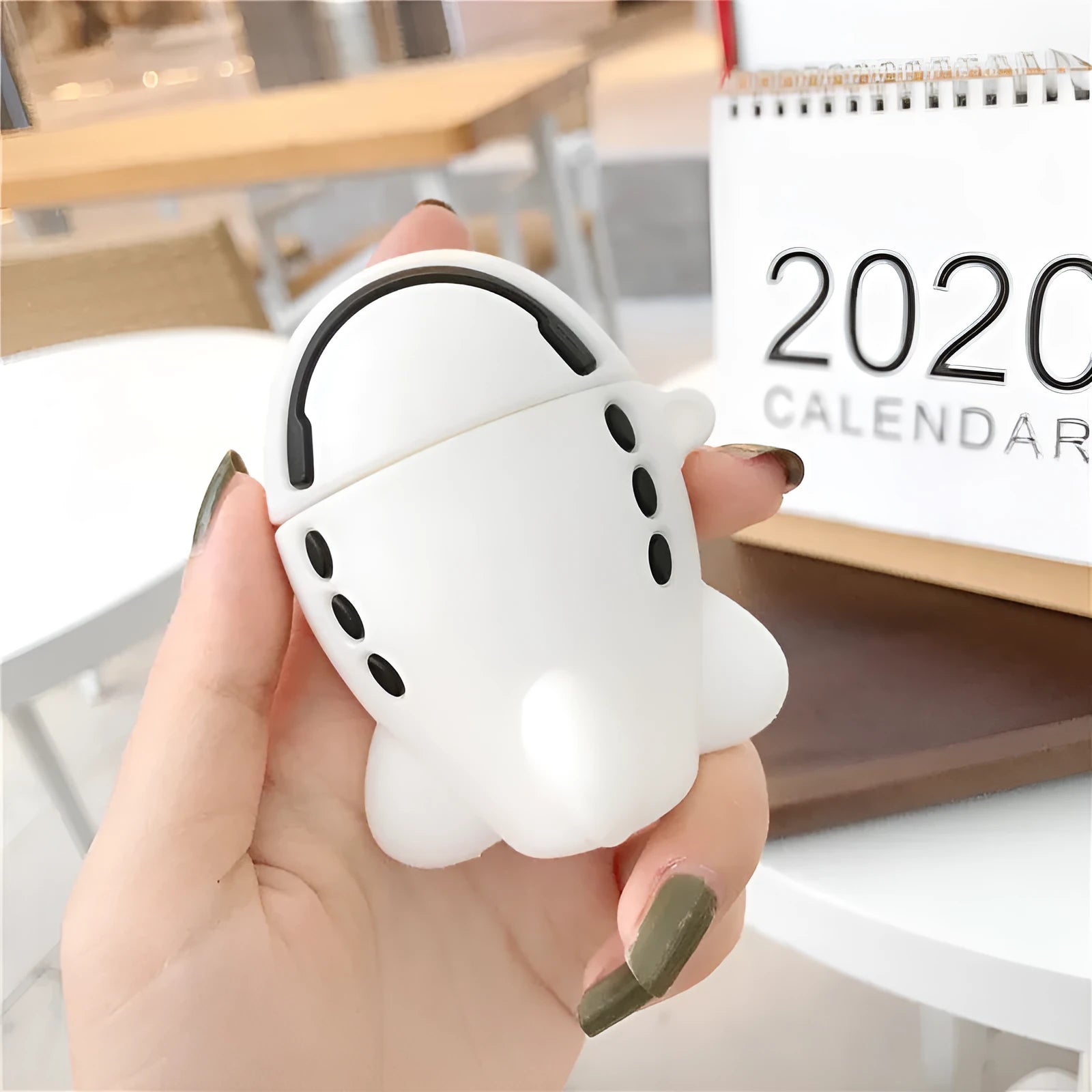 Silicone flip case with cartoon airplane design for Apple AirPods 1 and 2, includes attachment hook