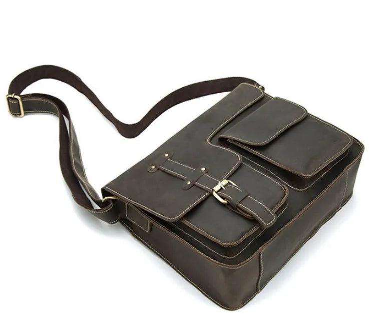 Brown leather vintage messenger bag with brass zipper and adjustable crossbody strap.