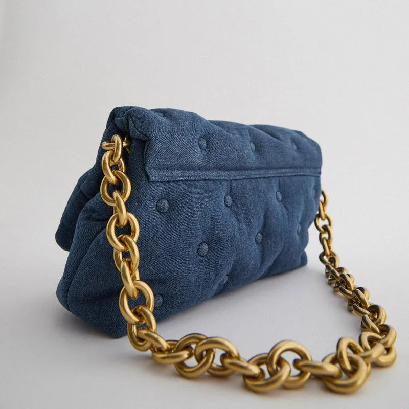 Blue oversized denim quilted shoulder bag with thick chain strap and padded buttons