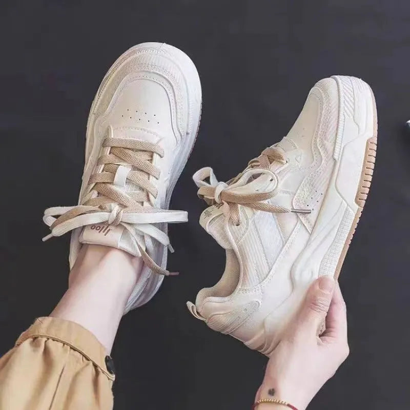 Women's beige and pink low-top rubber sole sneakers on a white background