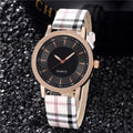 Women's fashion belt watch with round dial, leather strap, gold black colour, stainless steel case