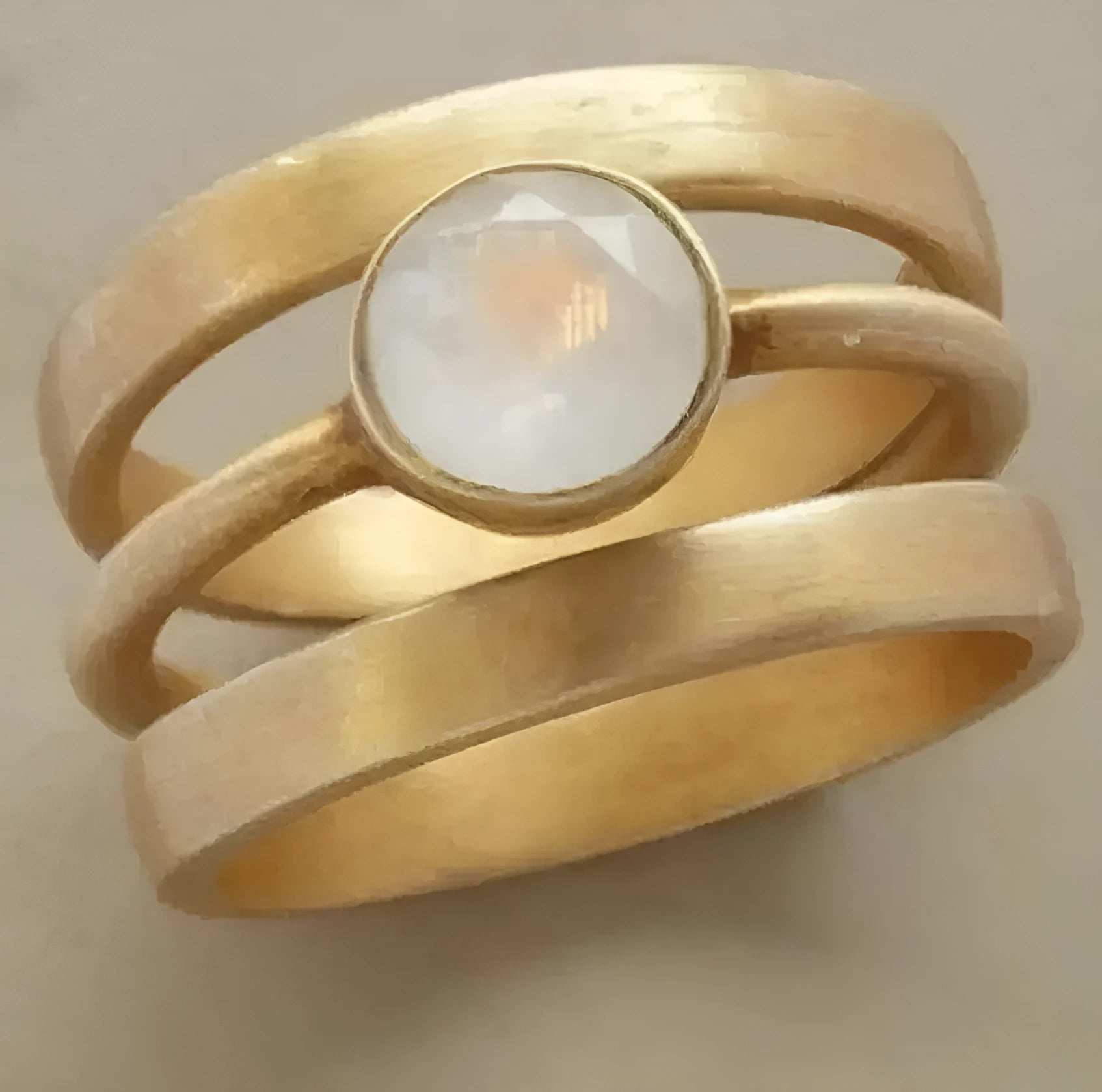 Gold-plated titanium steel ring with a white chalcedony stone in a hollow micro-inlaid geometric setting.