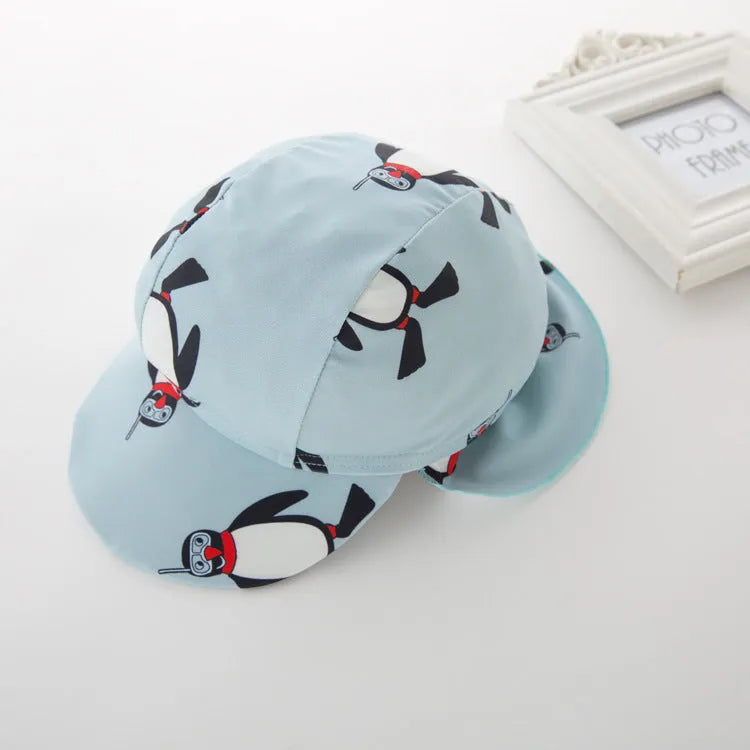 Boy's penguin print long sleeve swimsuit one-piece with matching swim cap for sun protection