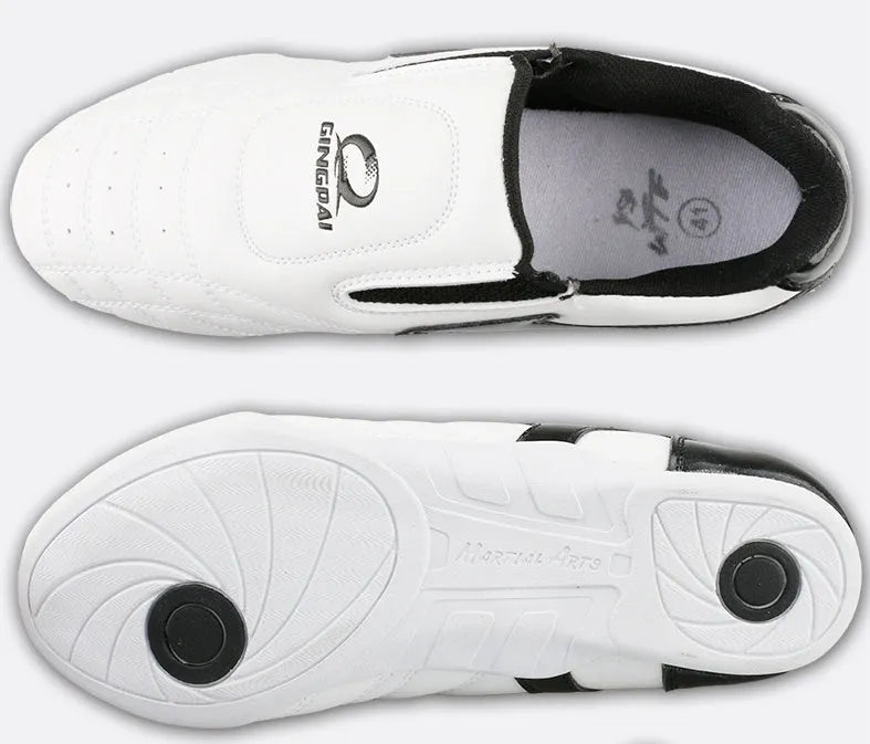 Black and white children's Sanda Taekwondo martial arts shoes with a soft sole and widened fit.