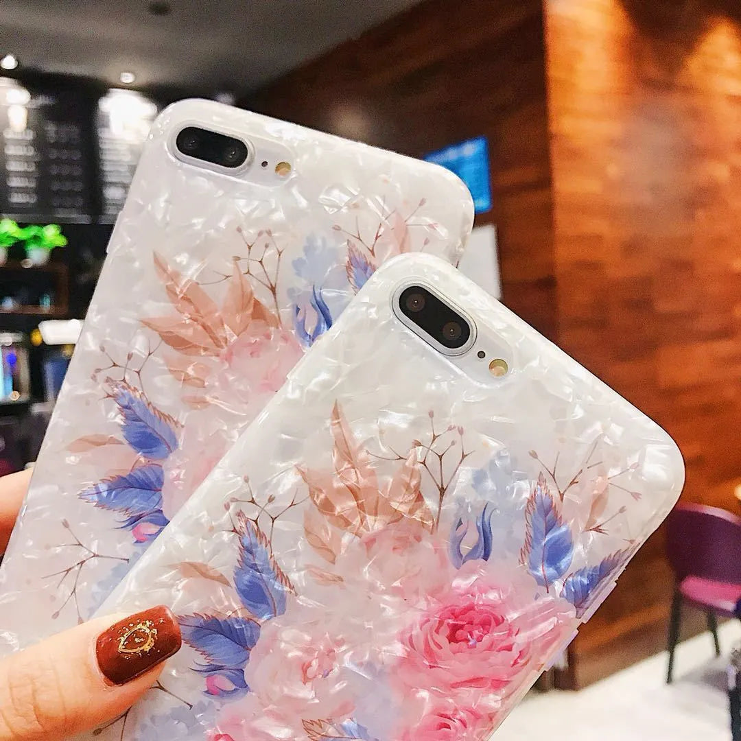 Dream Shell soft TPU iPhone case with rose flower pattern on back, shown in brown, purple and white.