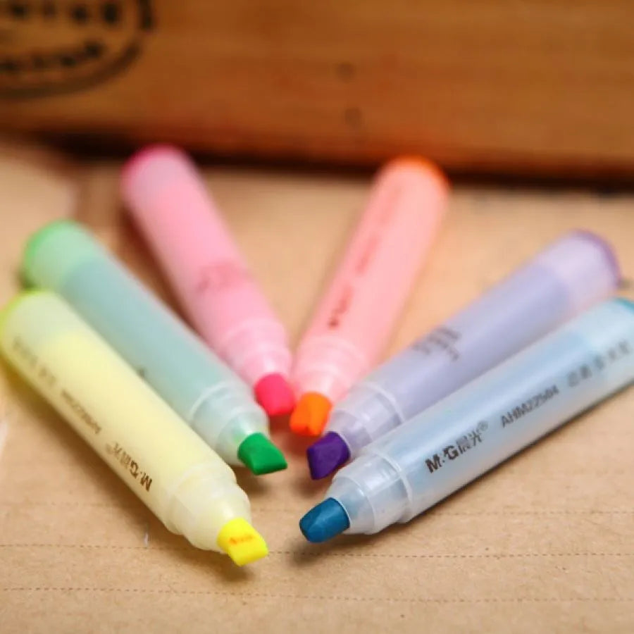 Set of six plastic highlighter pens in different colours with oblique pen shapes