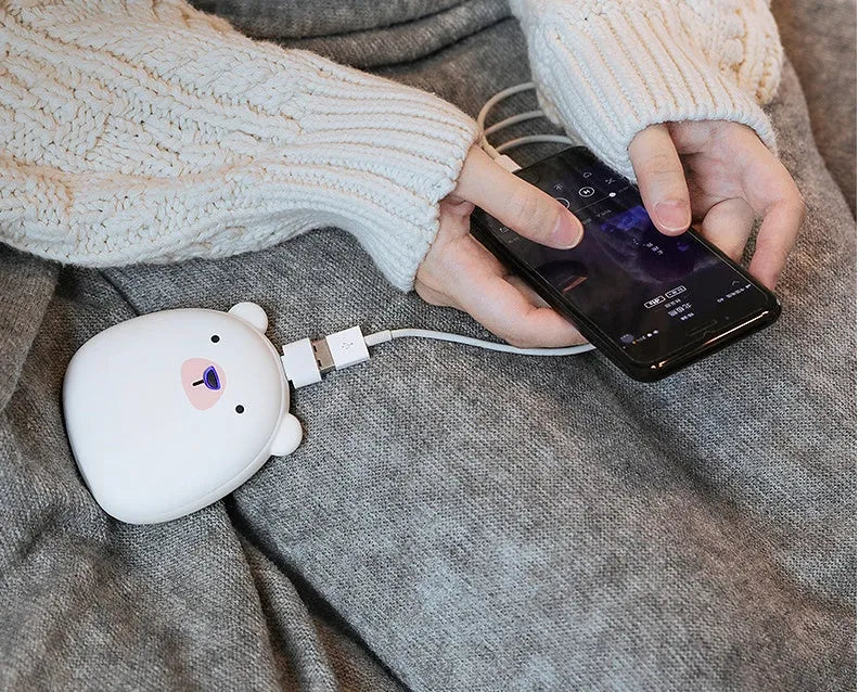 Cartoon penguin and polar bear USB rechargeable electric hand warmers showing dual-sided heating design