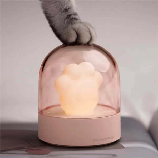 Grey cat paw USB charging music box night light with adjustable brightness on wooden desk