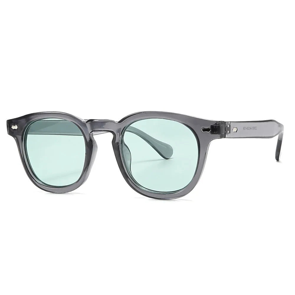 Simple round rim plastic sunglasses on a table showing bright black frame with blue lens.