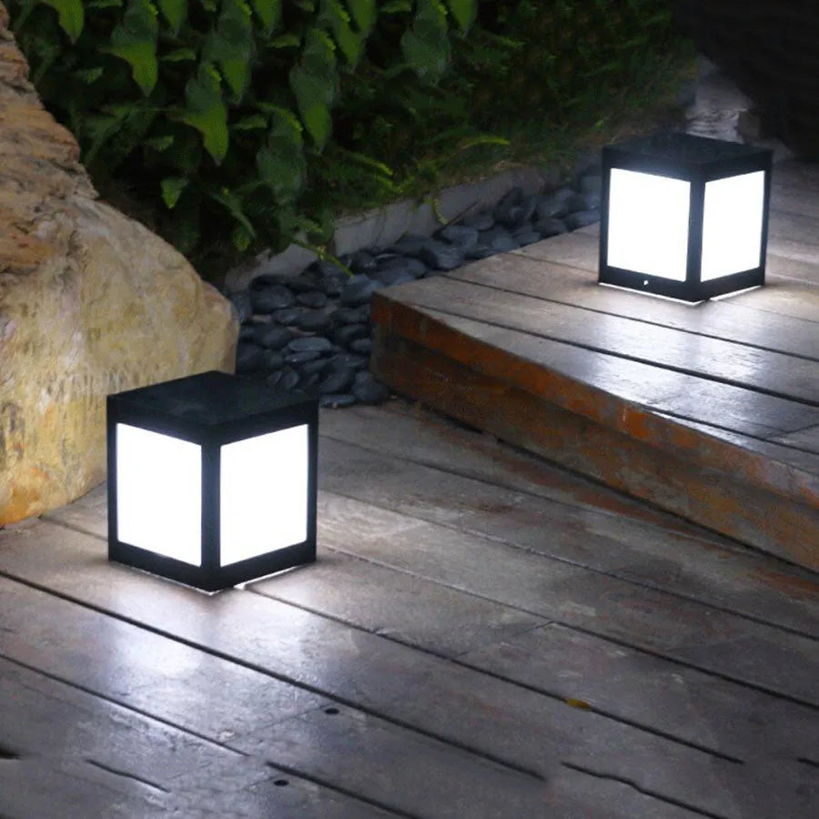 Waterproof solar-powered LED garden light installed on an outdoor wall.