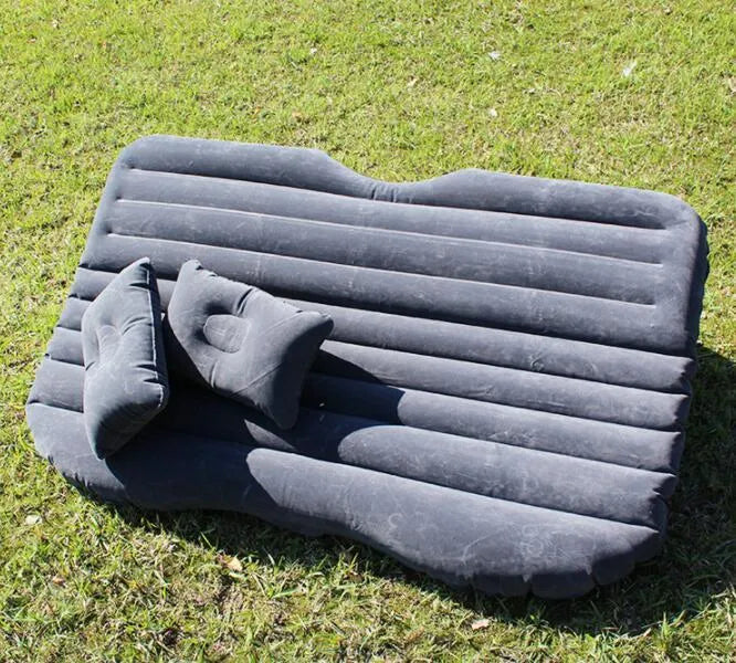 Universal inflatable car bed with flocked cloth, shown with two pillows and a pump.