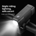Black USB rechargeable bicycle headlight with quick-release strap mount on handlebars.
