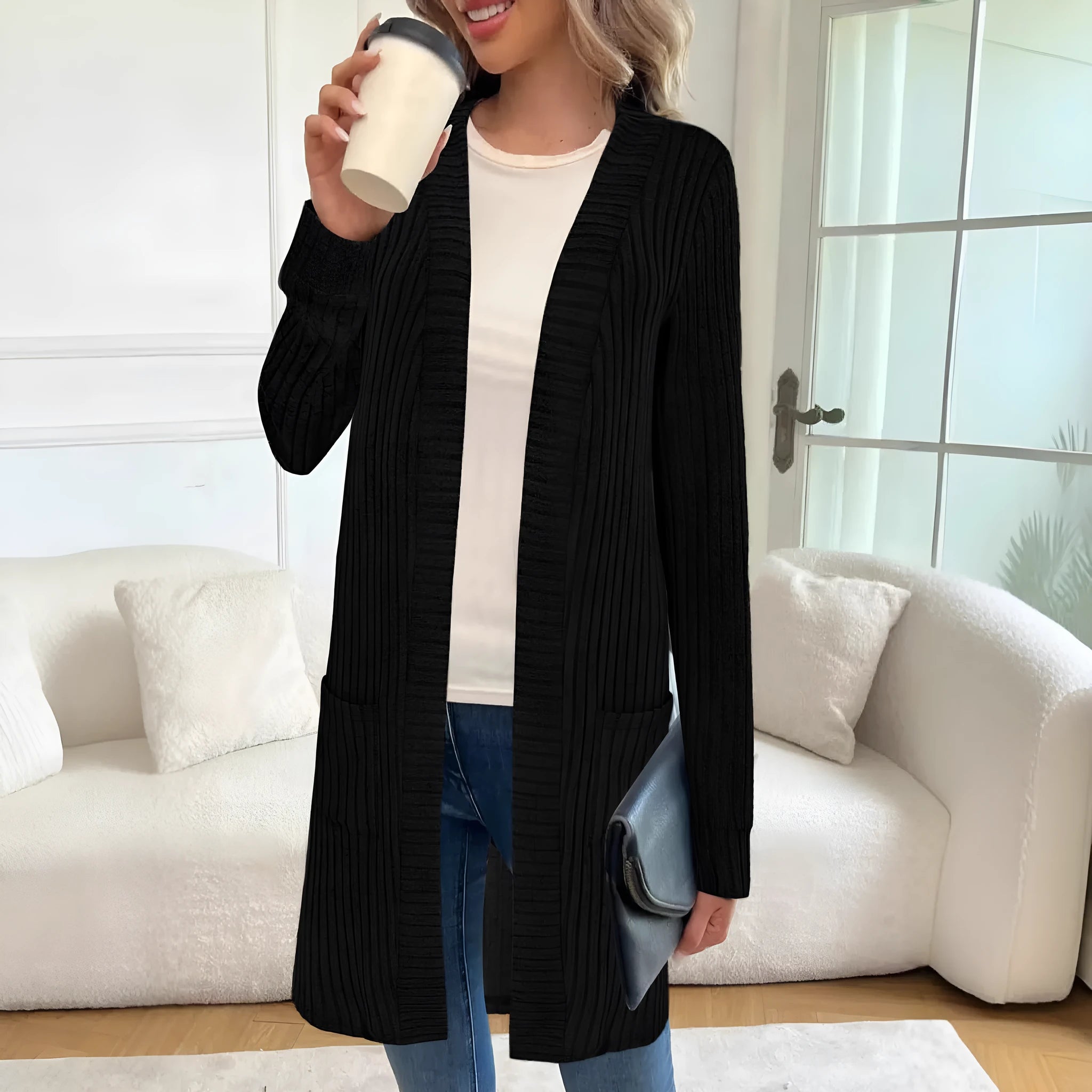 A woman wearing a loose-fit long sleeve knitted cardigan jacket with pockets, available in black, grey, or wine red.
