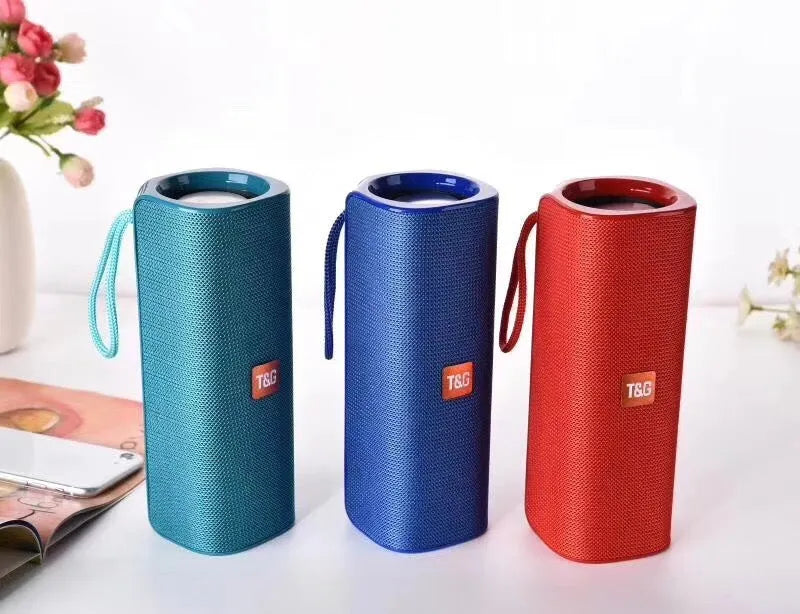 Fabric-covered portable Bluetooth speaker with USB port and control buttons