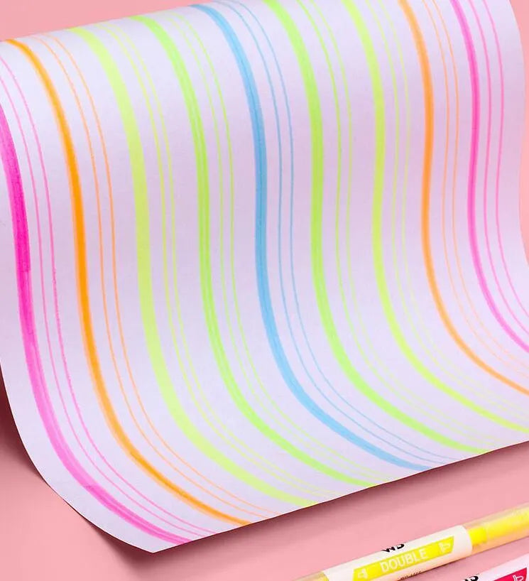 Six double-headed marker pens showing round and oblique nibs in assorted colours including orange, purple, yellow, green, blue, and pink