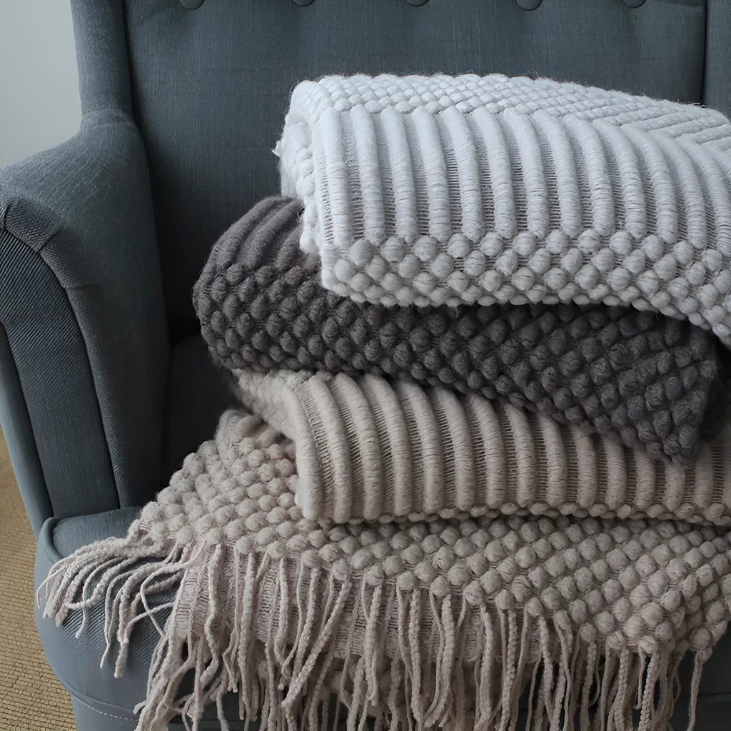 Lightweight grey polyester fibre nap blanket folded to show size 127 by 170 cm.