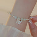 Women's butterfly jewellery set with bracelet and necklace featuring silver electroplated finish and Hetian jade details