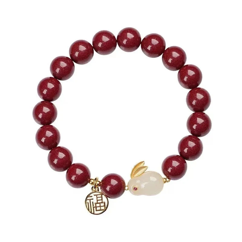 Purple Gold Sand cinnabar bracelet with jade hare charm, shown in 6mm and 8mm bead sizes.