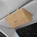 Suede car glasses storage box in beige attached to car sun visor holding sunglasses and phone