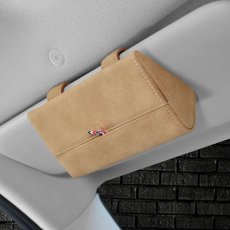 Suede car glasses storage box in beige attached to car sun visor holding sunglasses and phone
