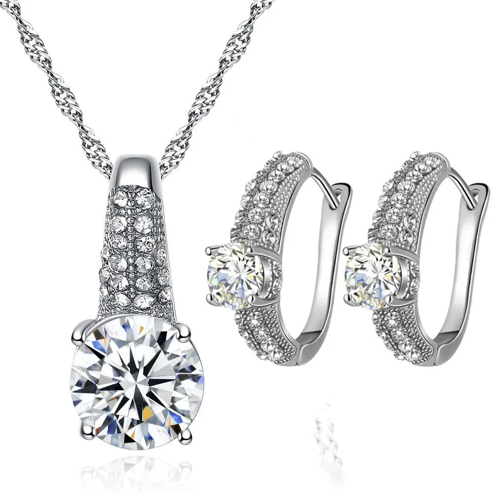 Gold and silver bridal necklace and earring set with copper base platinum finish on display