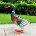 Wrought iron swan solar garden light with warm white LED on a lawn