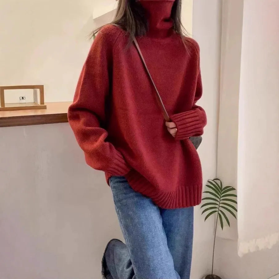 Red women's loose turtleneck sweater with a thick curling pile collar and a 3D pattern texture.