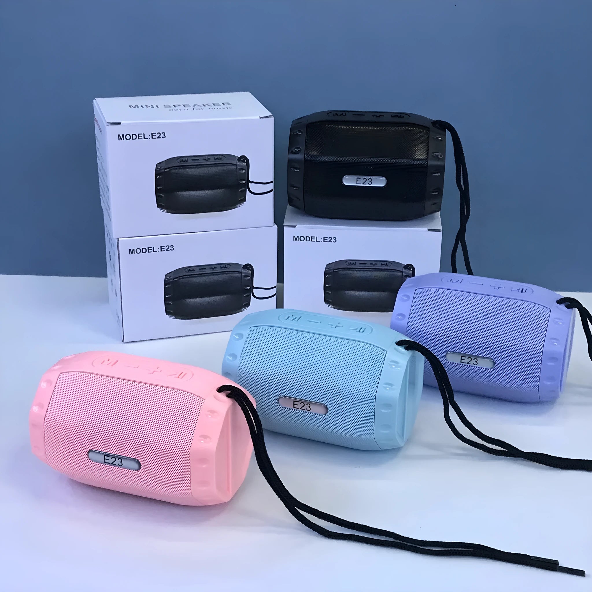 Compact USB Bluetooth wireless speaker in black, blue, pink, or purple colour options.