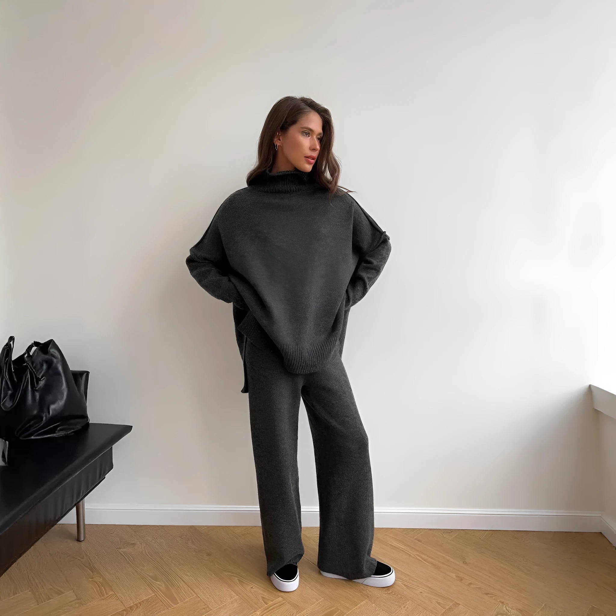 Women's solid colour acrylic sweater and trousers suit set with a side-slit top design.