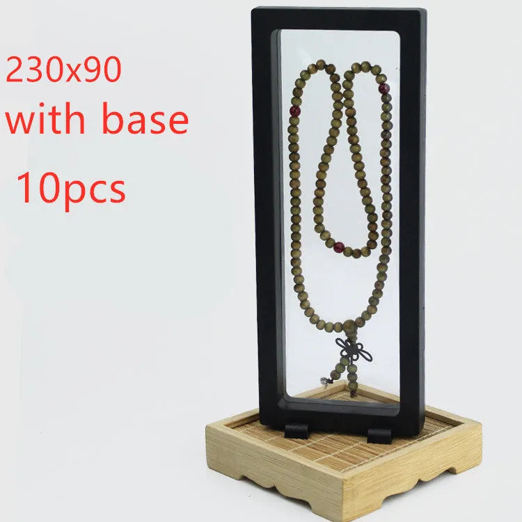 3D floating display box with ABS frame and clear TPU films, shown in black or white, for coins, medals, stamps, and jewellery.