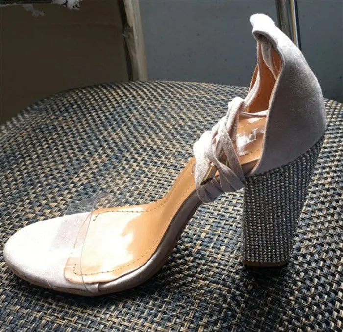 Pointed-toe black and gold ladies high heels with a plastic upper and sole.