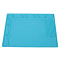 Blue silicone watch repair desk mat on a workbench, showing non-slip surface for watch components.