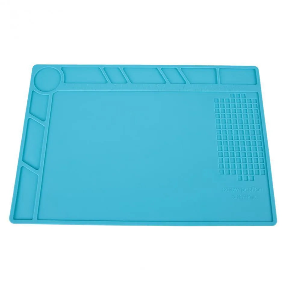 Blue silicone watch repair desk mat on a workbench, showing non-slip surface for watch components.