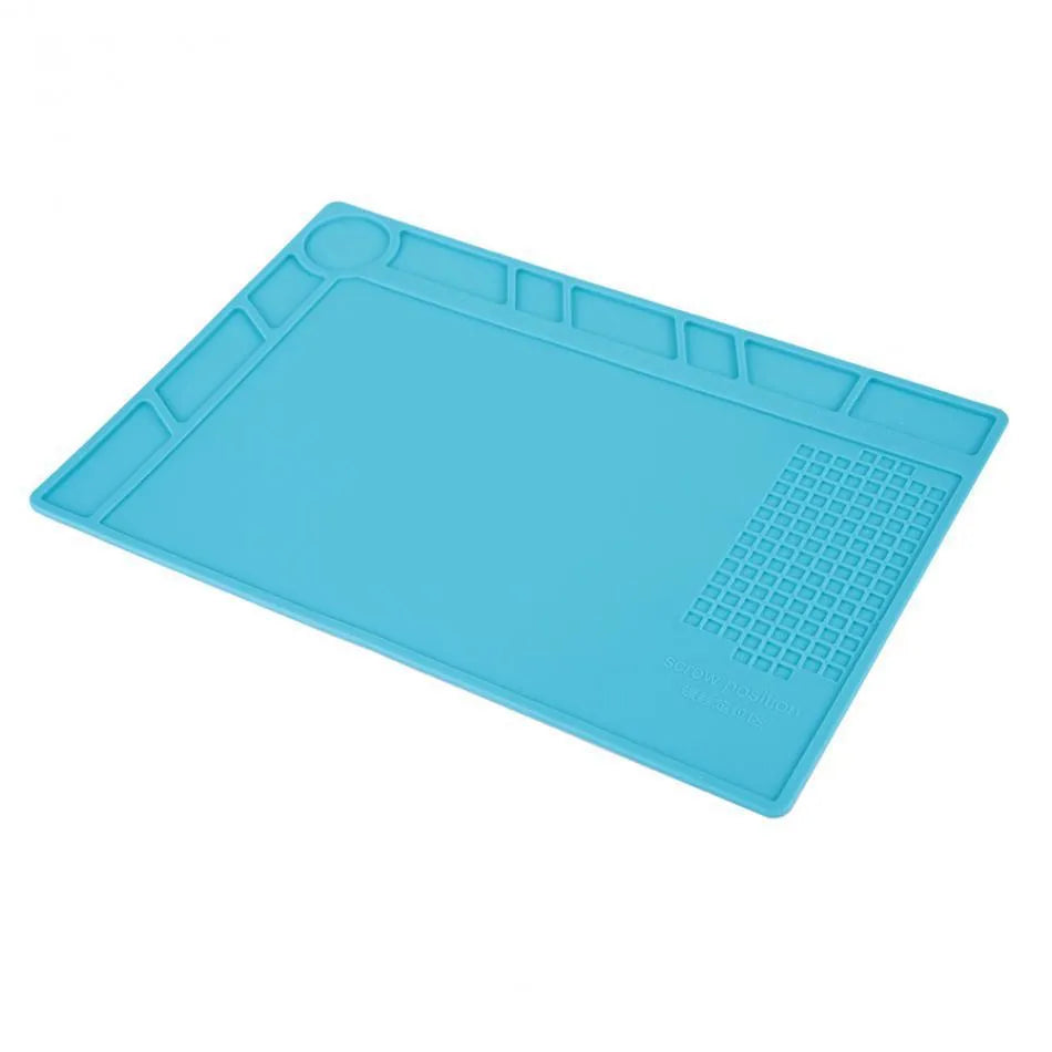 Blue silicone watch repair desk mat on a workbench, showing non-slip surface for watch components.
