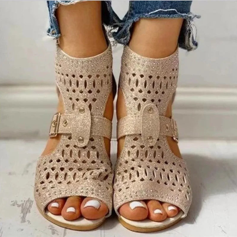 Women's beige sandals with back zipper closure and wedge heel on wooden floor