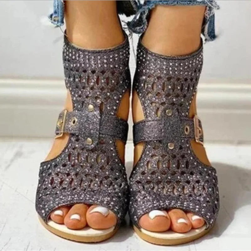 Women's beige sandals with back zipper closure and wedge heel on wooden floor