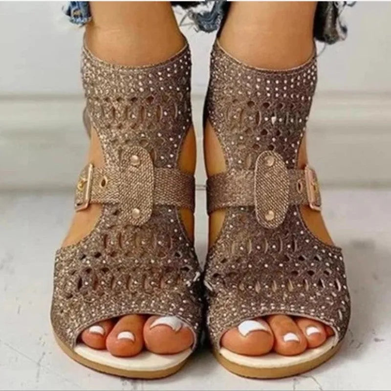 Women's beige sandals with back zipper closure and wedge heel on wooden floor