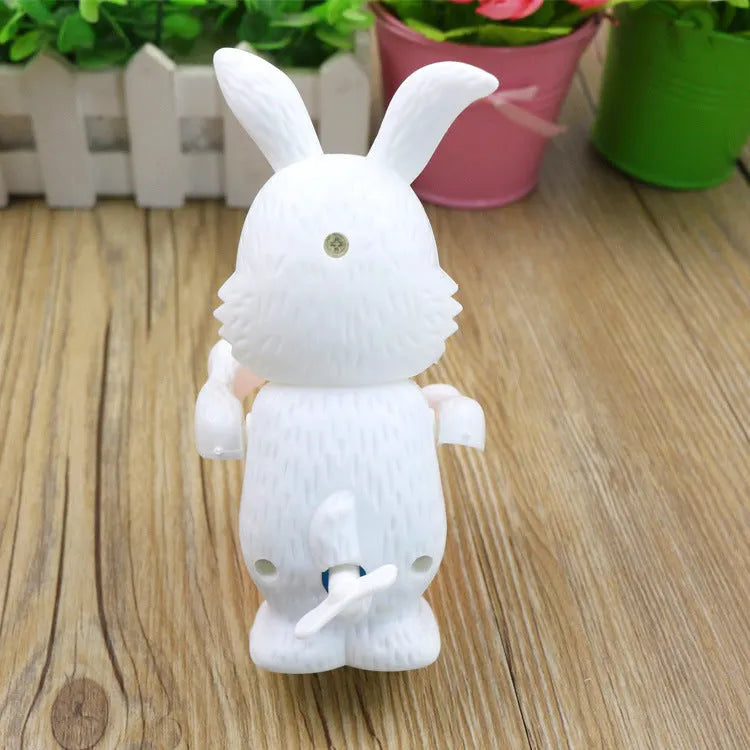 White Cartton rabbit drumming clockwork wind-up toy on a flat surface