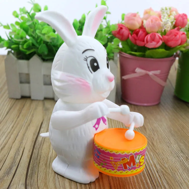 White Cartton rabbit drumming clockwork wind-up toy on a flat surface