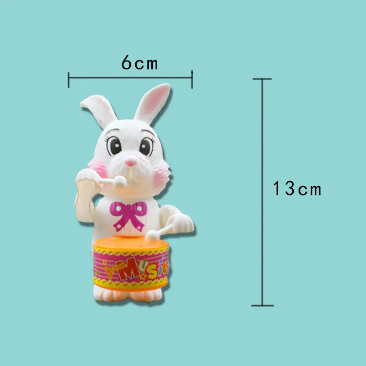 White Cartton rabbit drumming clockwork wind-up toy on a flat surface