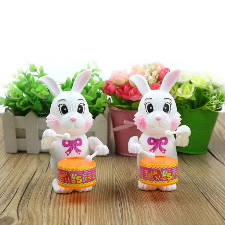 White Cartton rabbit drumming clockwork wind-up toy on a flat surface
