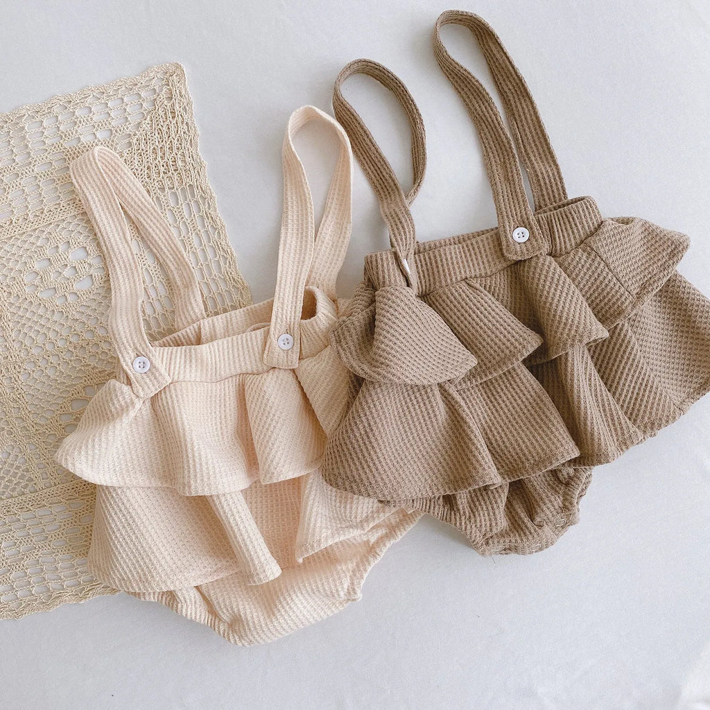 Baby romper climber suit with triangle design and pleated lotus leaf sling in cotton fabric