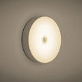 Small white round motion sensing LED night light with USB charging port