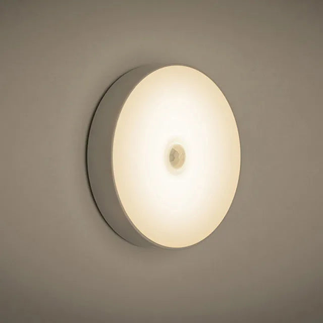 Small white round motion sensing LED night light with USB charging port